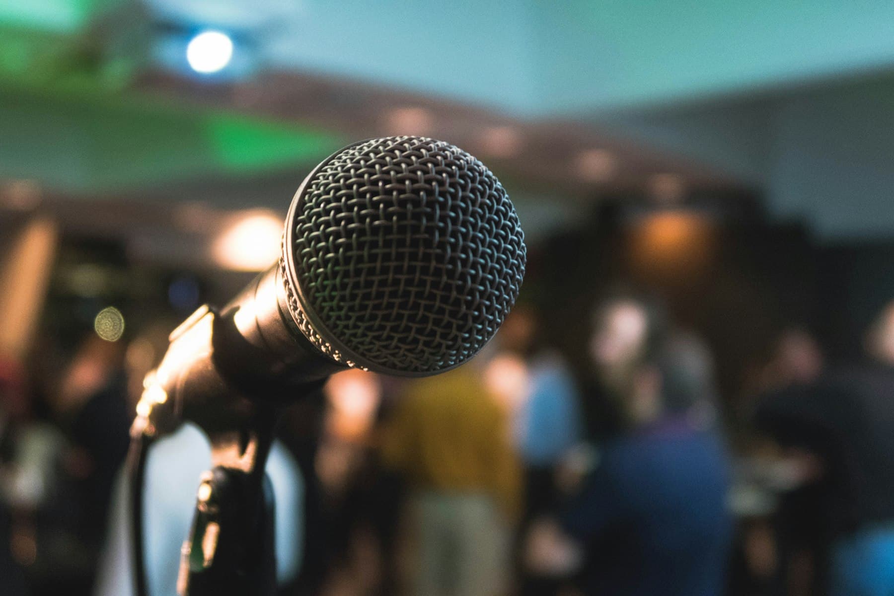 A microphone in front of a busy event floor